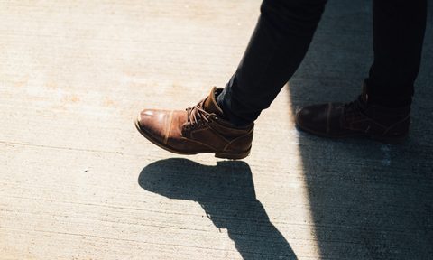 Person wearing brown leather ankle boots