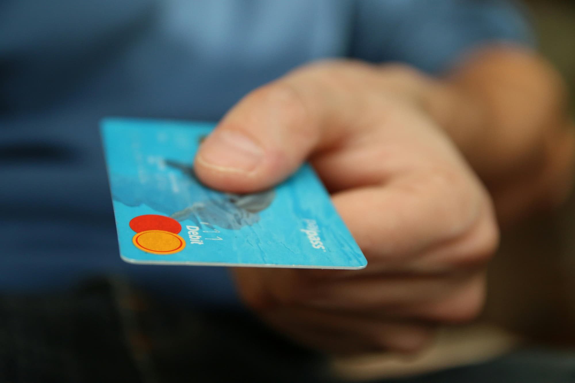 person holding blue credit card