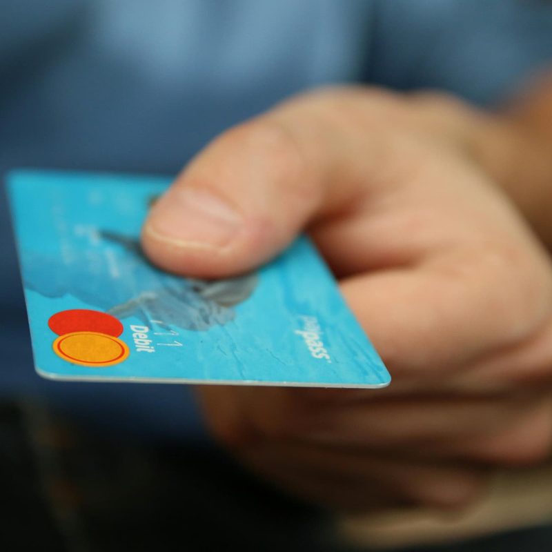 person holding blue credit card