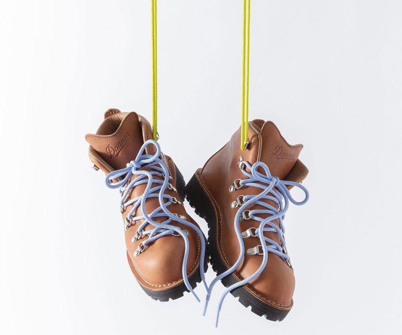 brown boots hanging by yellow laces