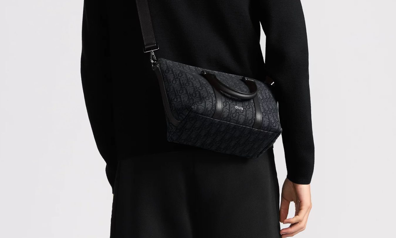 Man wearing Dior Weekender 25 bag