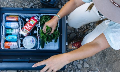 Woman looking into a Dometic CFX5 series portable fridge/freezer