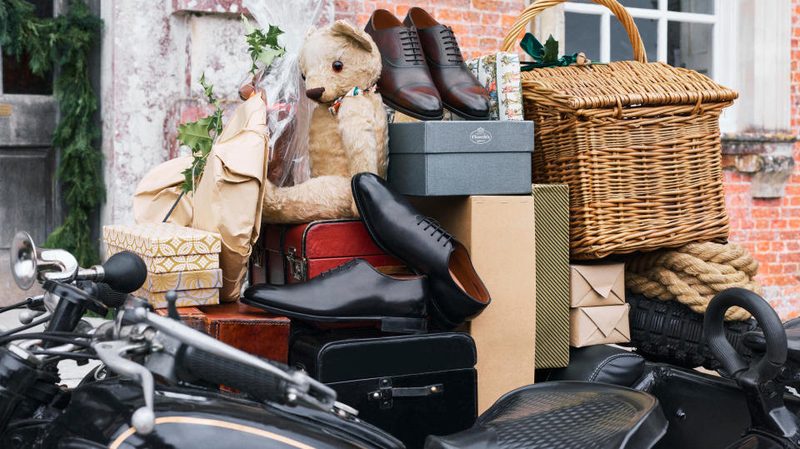 shoes piled on top of boxes and stuffed animals