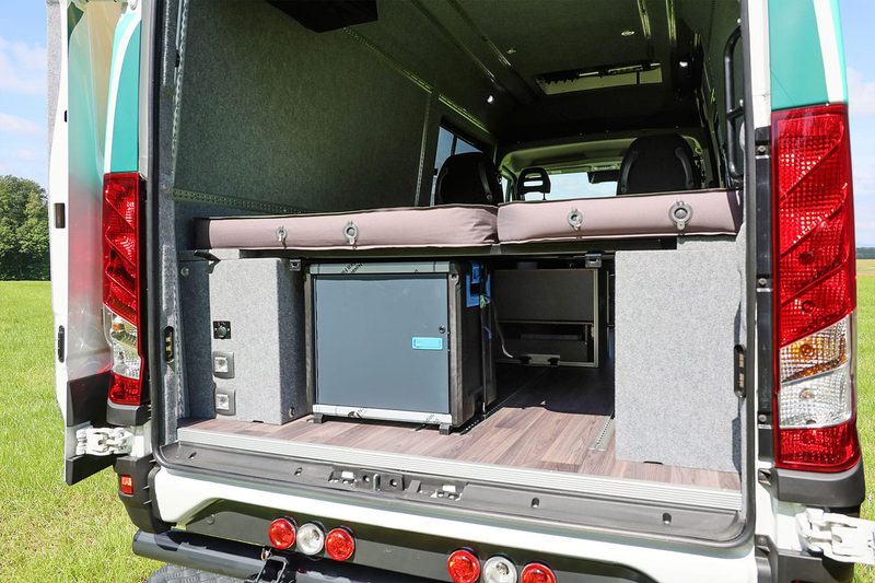 Rear sleeping quarters setup inside an Iveco Daily Switch 4x4 camper van.
