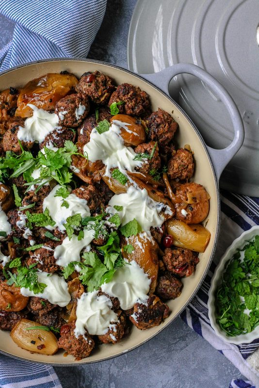 big plate of food meat and vegetables in pan on table