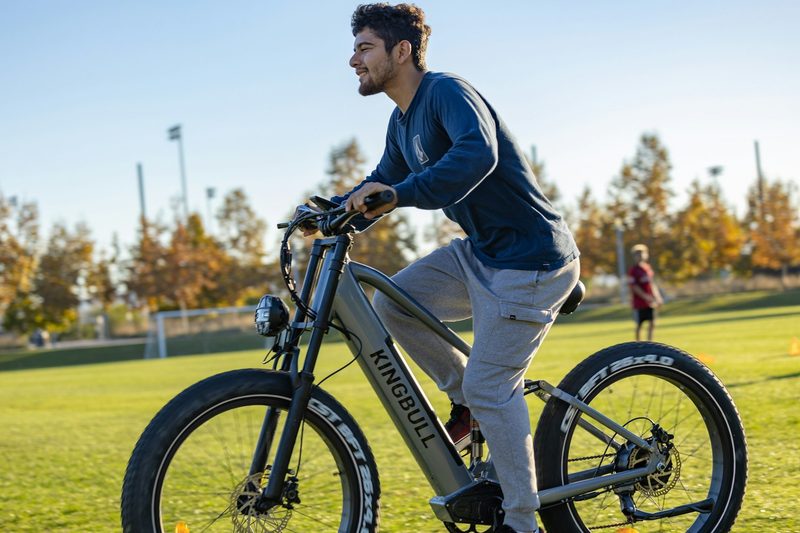 man cycling outside on the grass