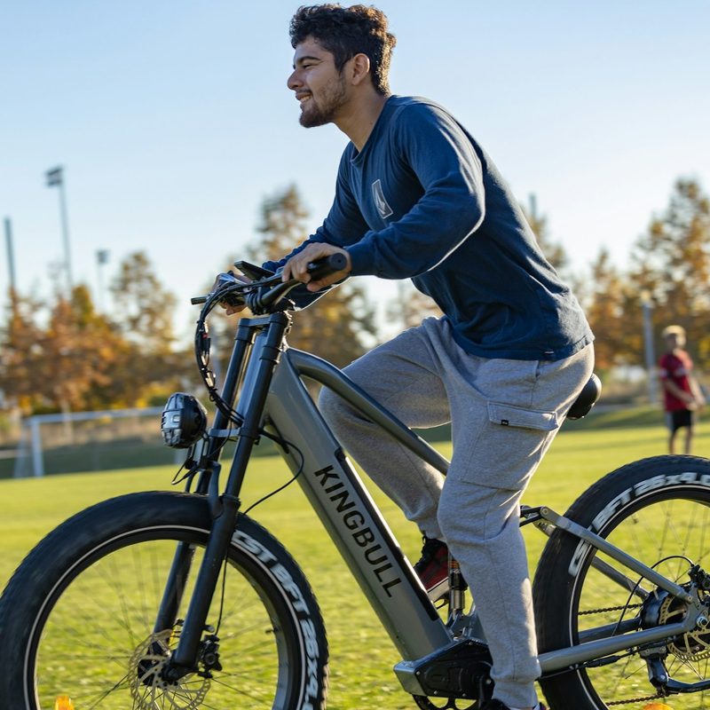 man cycling outside on the grass