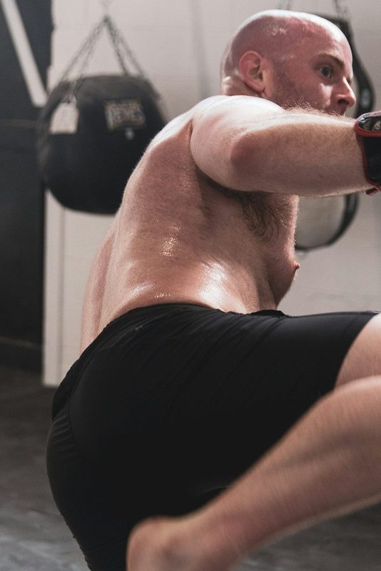 man boxing shirtless gym boxing gloves
