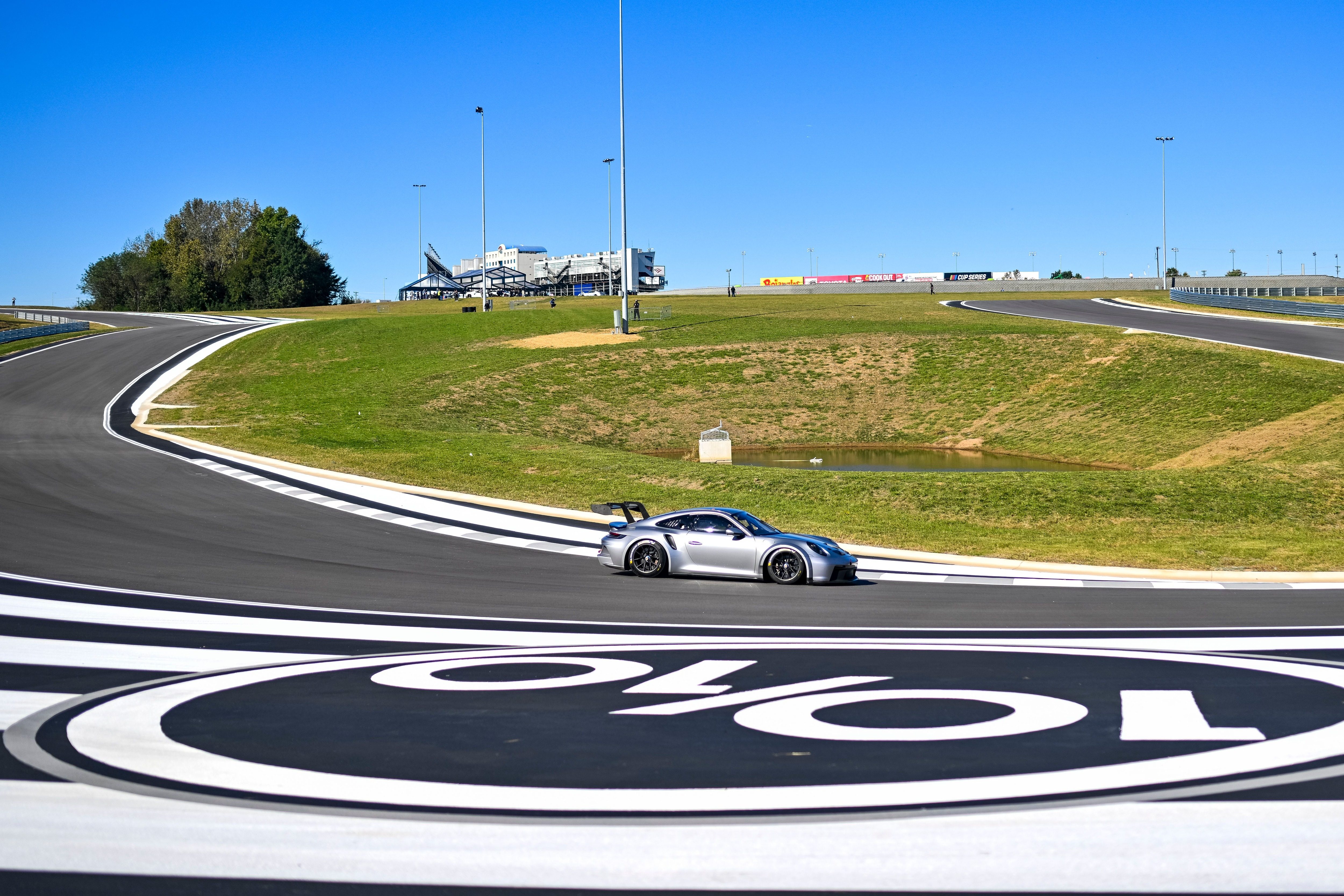 A silver Porsche GT2RS driving the track at Ten Tenths Motor Club