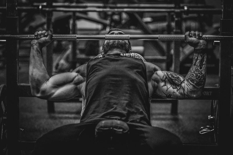 man lifting weights muscle bench press barbell black and white