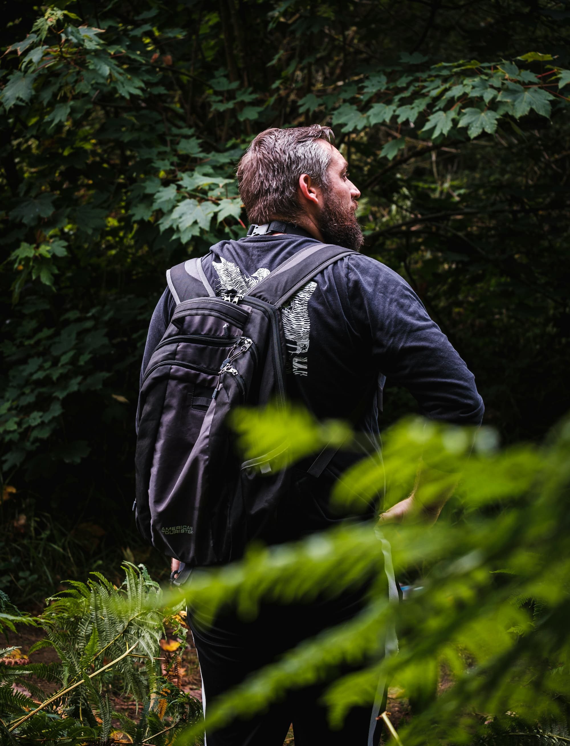 man in forest with backpack on