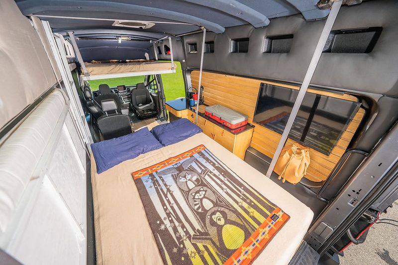 Rear bed down in "Sleep Mode" inside the Orion 365 camper van.