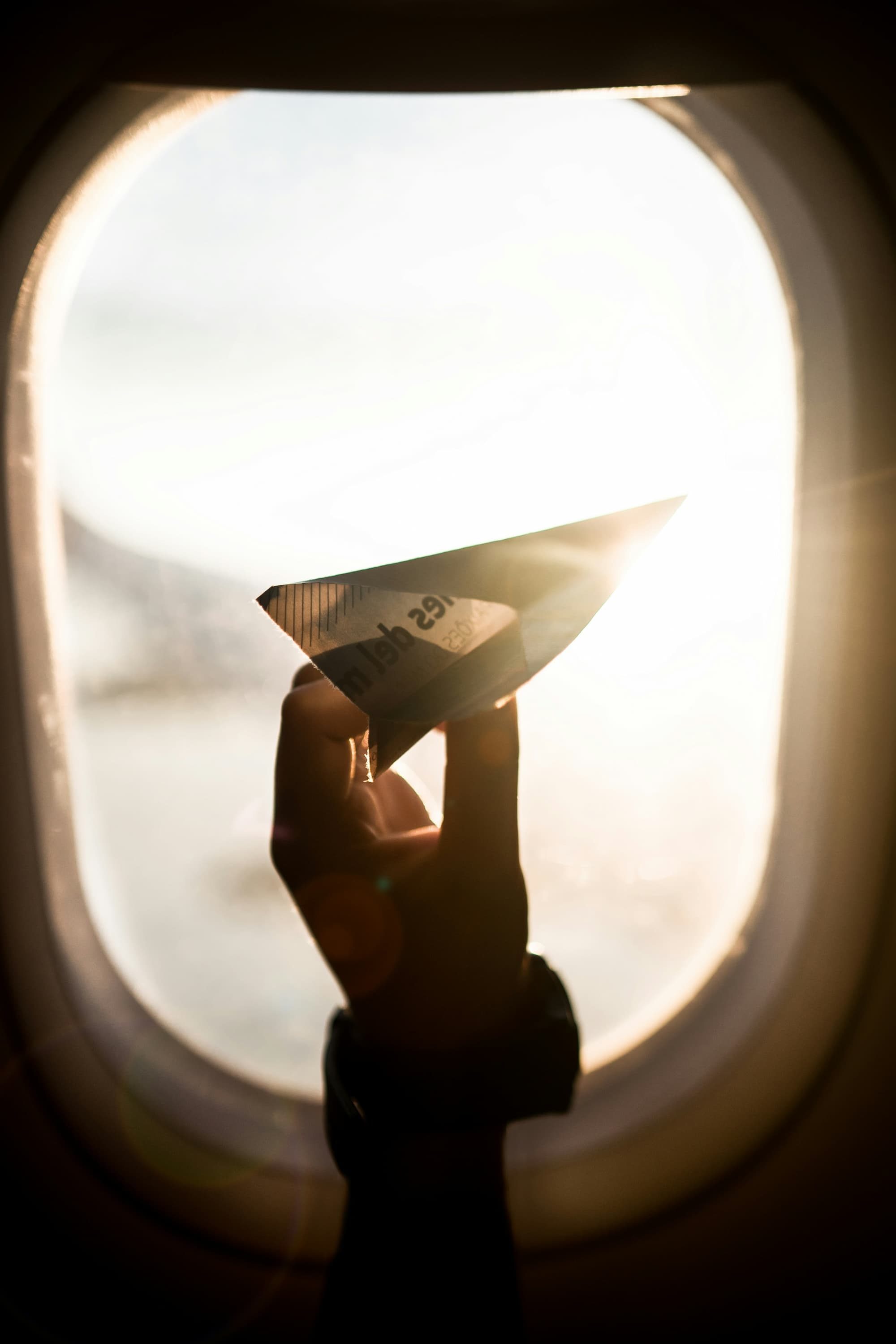 person holding a paper airplane