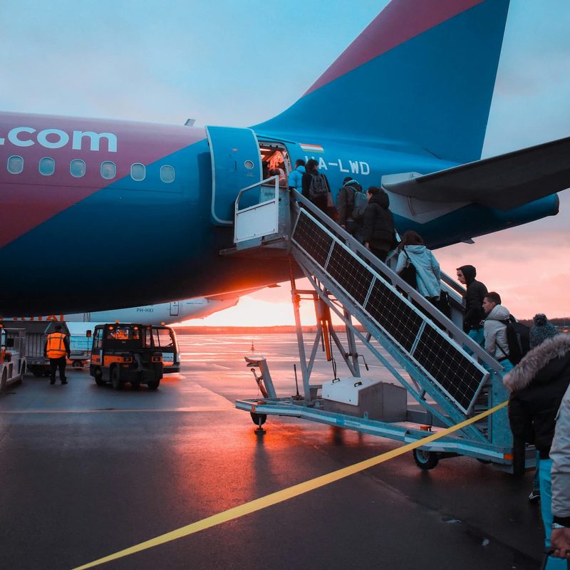 people boarding a plane outside