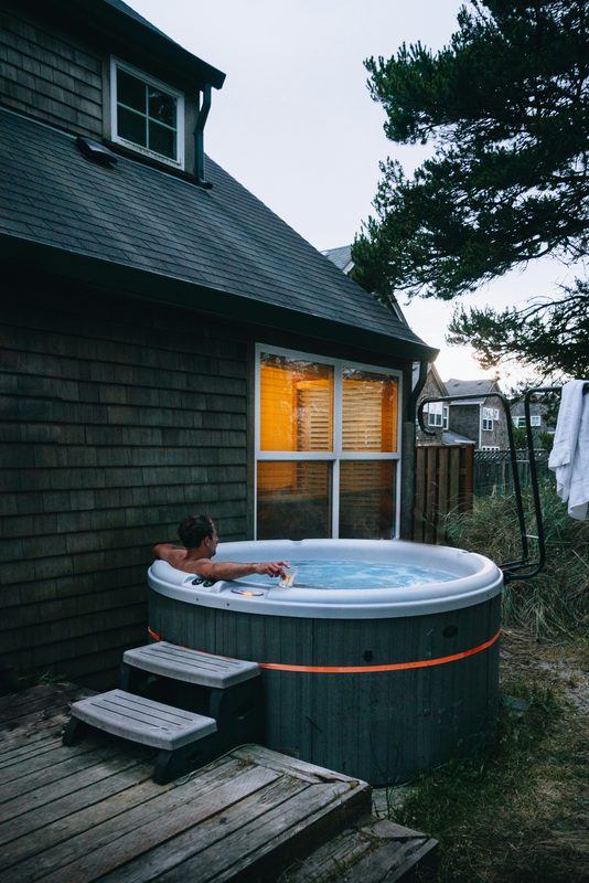 man in hot tub relax outside house