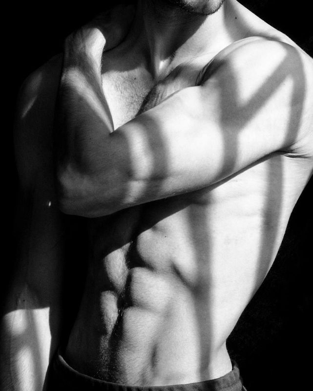 man doing shirtless wearing hat black background muscle abs