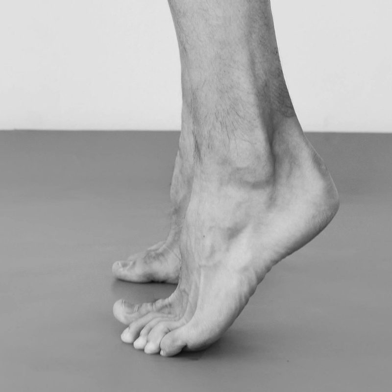 Man legs doing calf raise with muscles showing