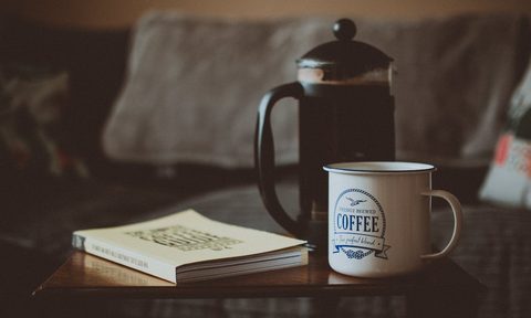 French press with a coffee cup