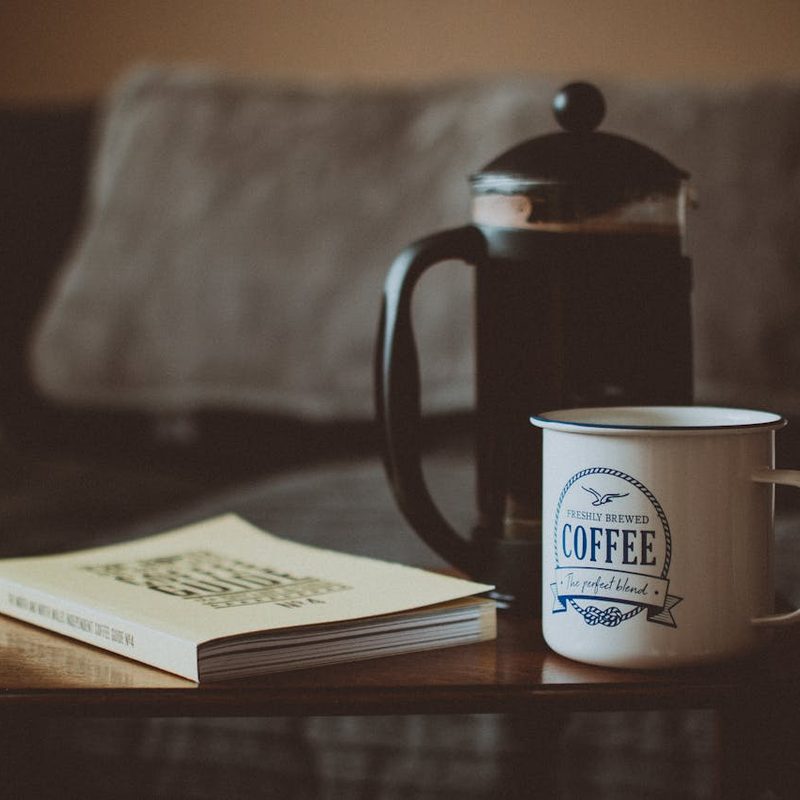 French press with a coffee cup