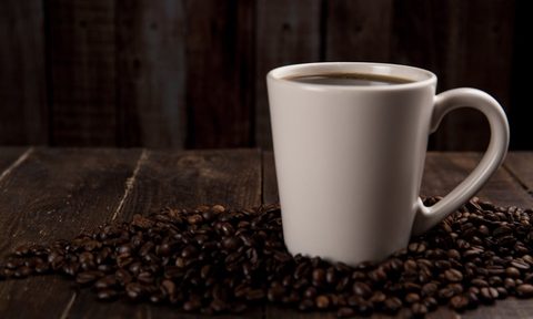 Cup of coffee with coffee beans