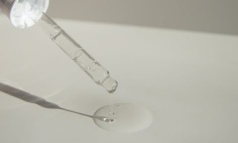a person applying serum to a countr