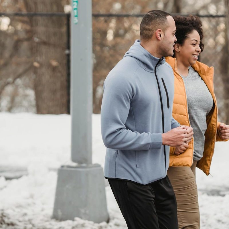 Man and woman running outdoors in cold