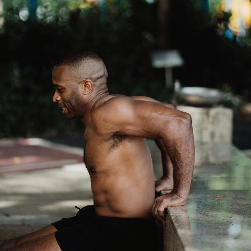 Man outside doing tricep dip bench dip on wall