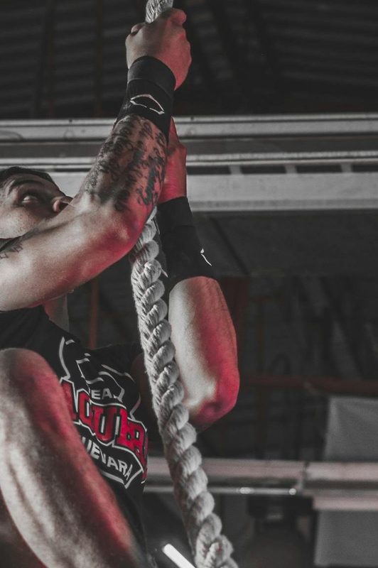 high intensity interval training man climbing a rope circuit training high intensity exercise