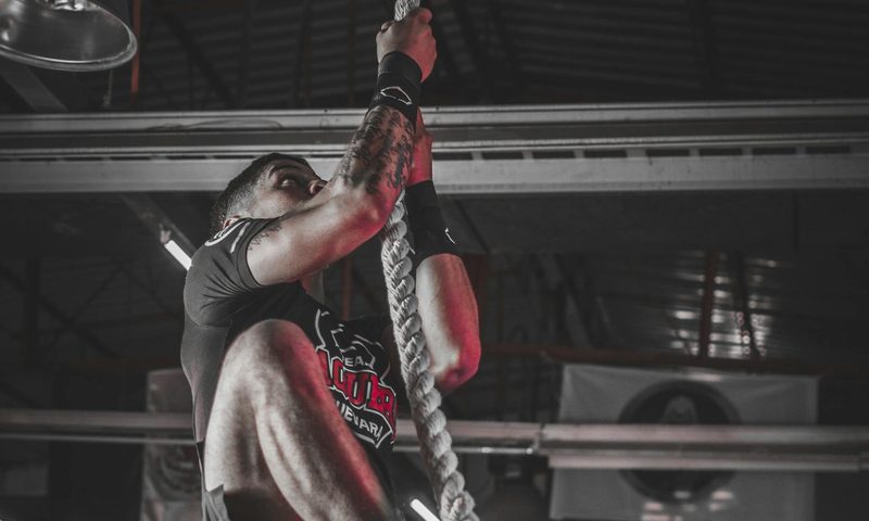 high intensity interval training man climbing a rope circuit training high intensity exercise