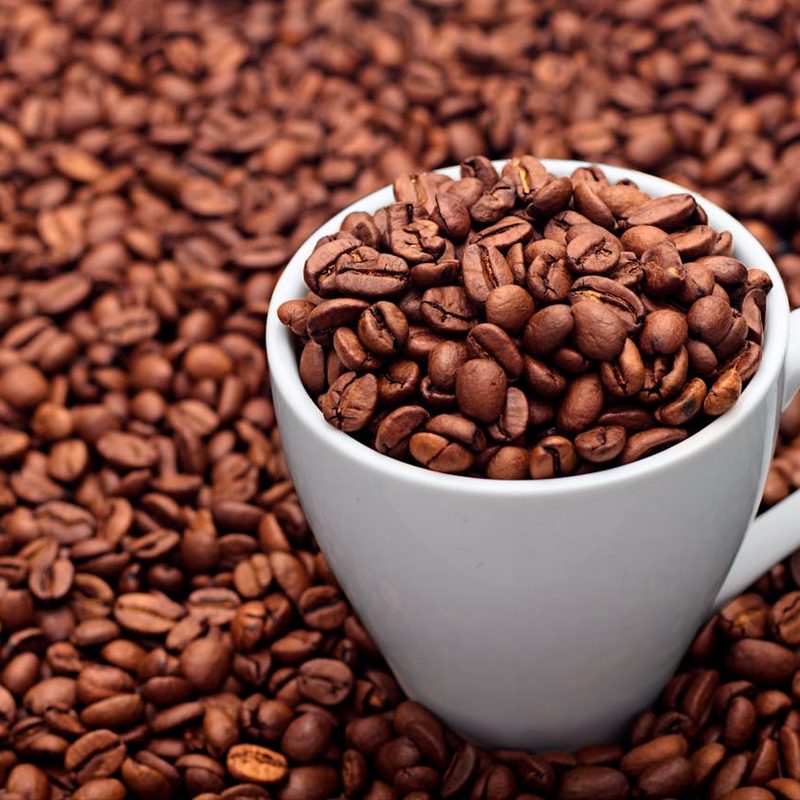 Cup of whole bean coffee