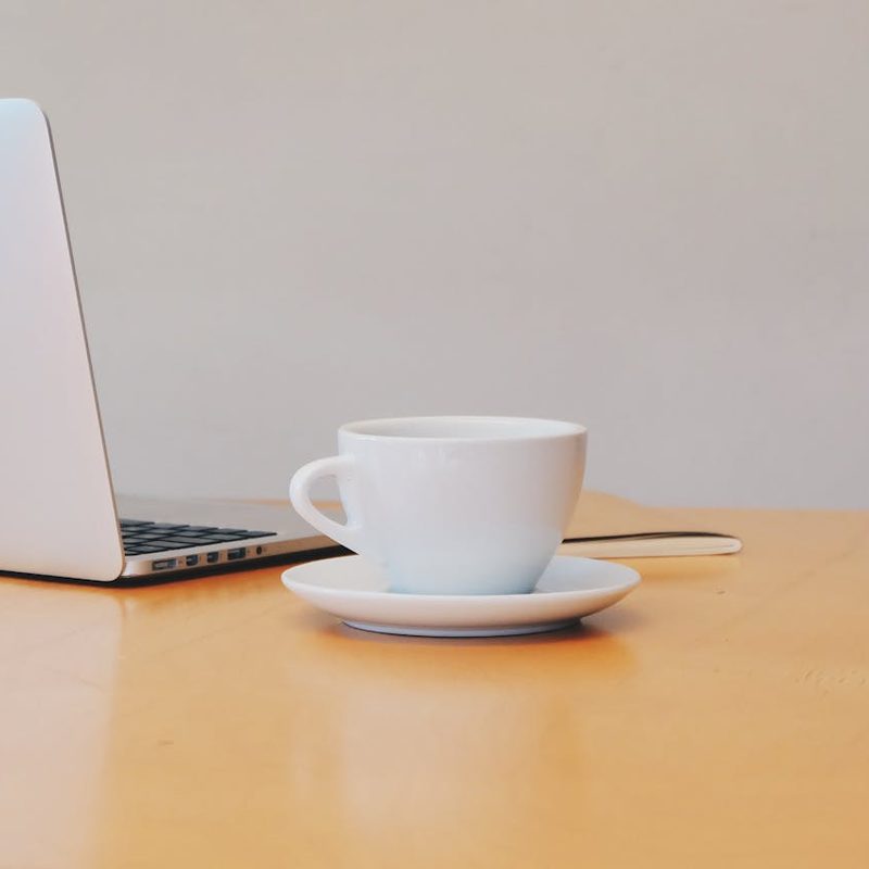 Coffee next to a laptop