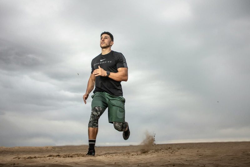 man exercising running around outdoors dark grey sky