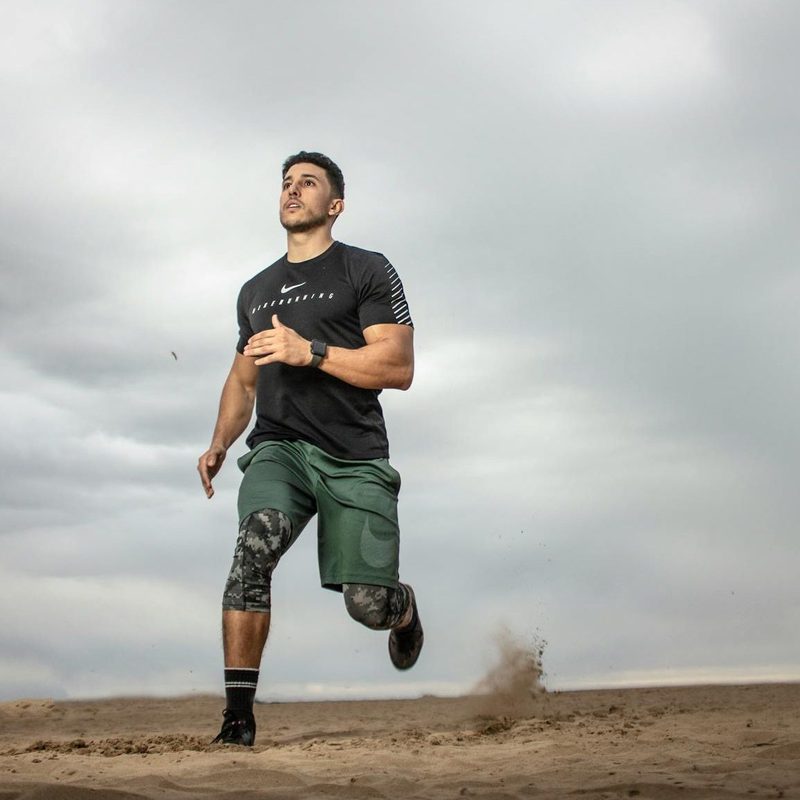 man exercising running around outdoors dark grey sky