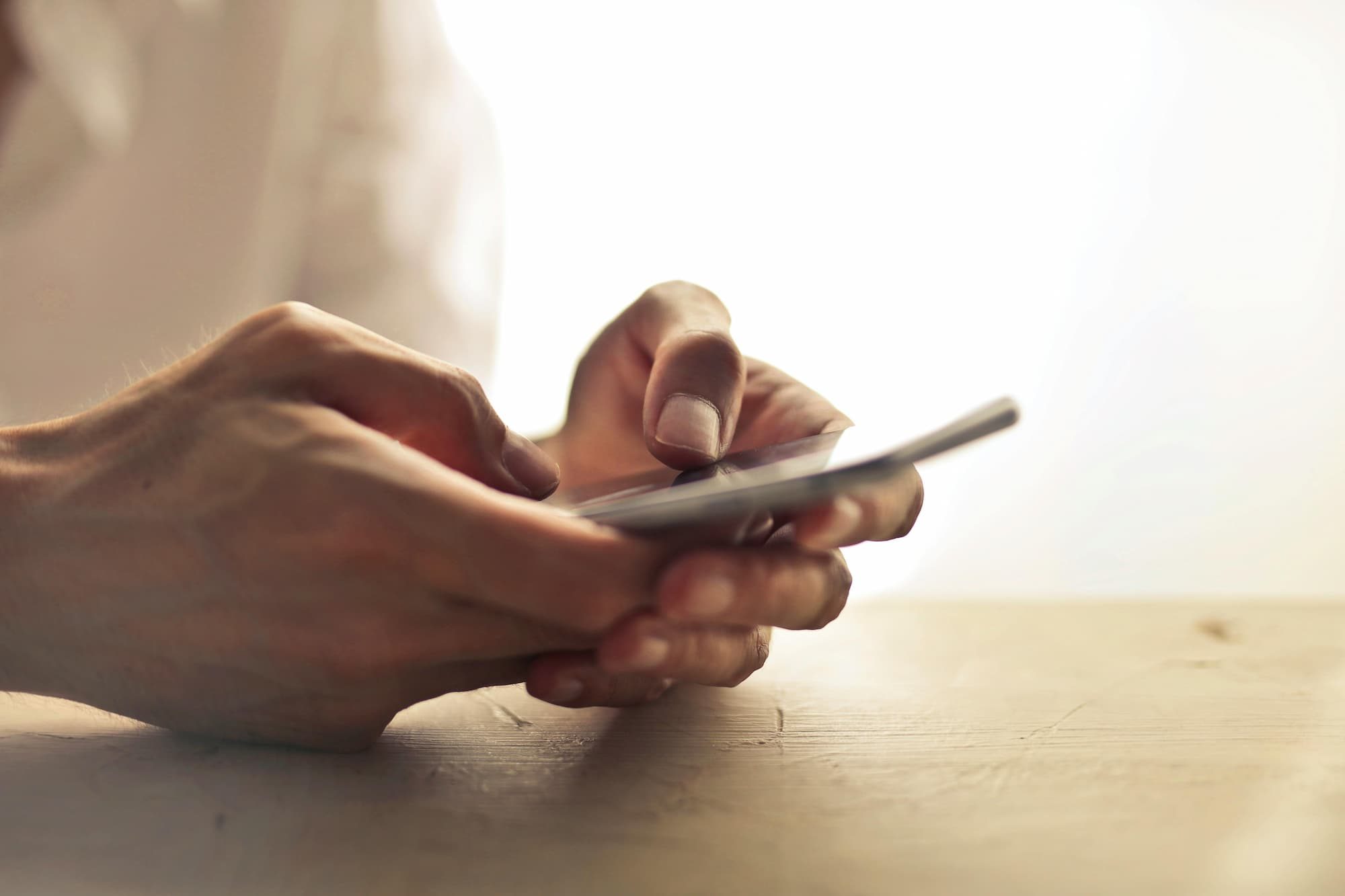 person typing on phone