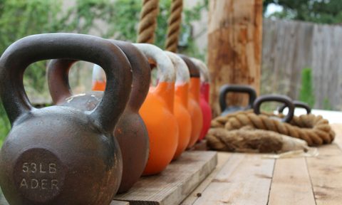 Row of kettlebells outside workout equipment
