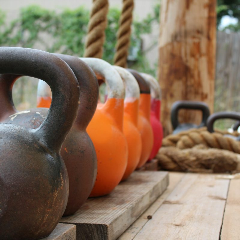 Row of kettlebells outside workout equipment