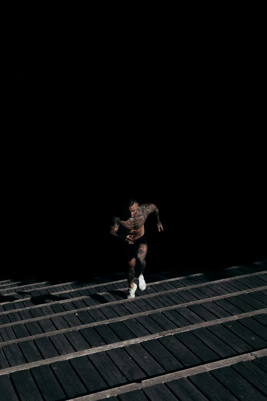man running on stairs dark background