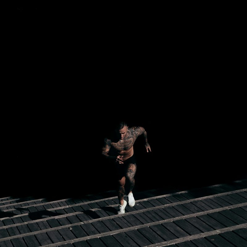 Man running on stairs dark background