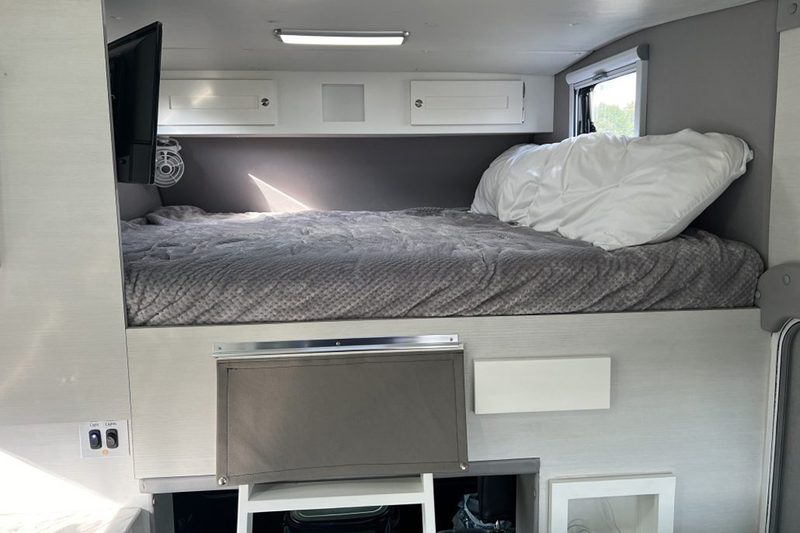 Overcab sleeping quarters with a queen mattress inside Tiger Adventure Vehicles' 2024 Panthera off-road camper.