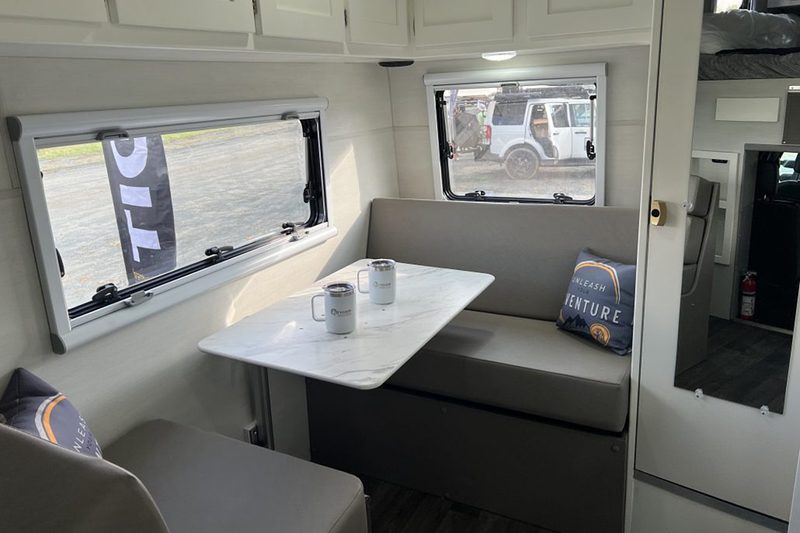 Convertible dinette/bed inside Tiger Adventure Vehicles' 2024 Panthera off-road camper truck.