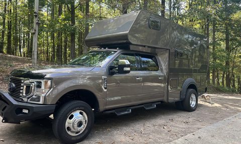 Tiger Adventure Vehicles' Panthera off-road truck camper parked on forest road.