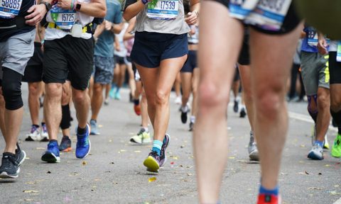 marathon runners legs on road