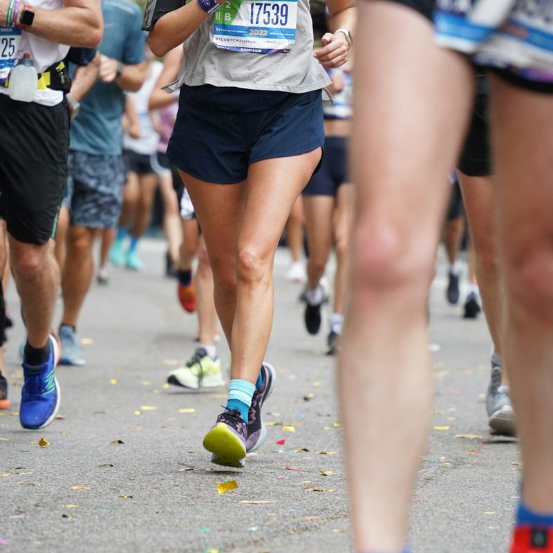 marathon runners legs on road