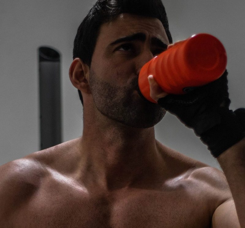 shirtless man drinking protein shake drink muscle