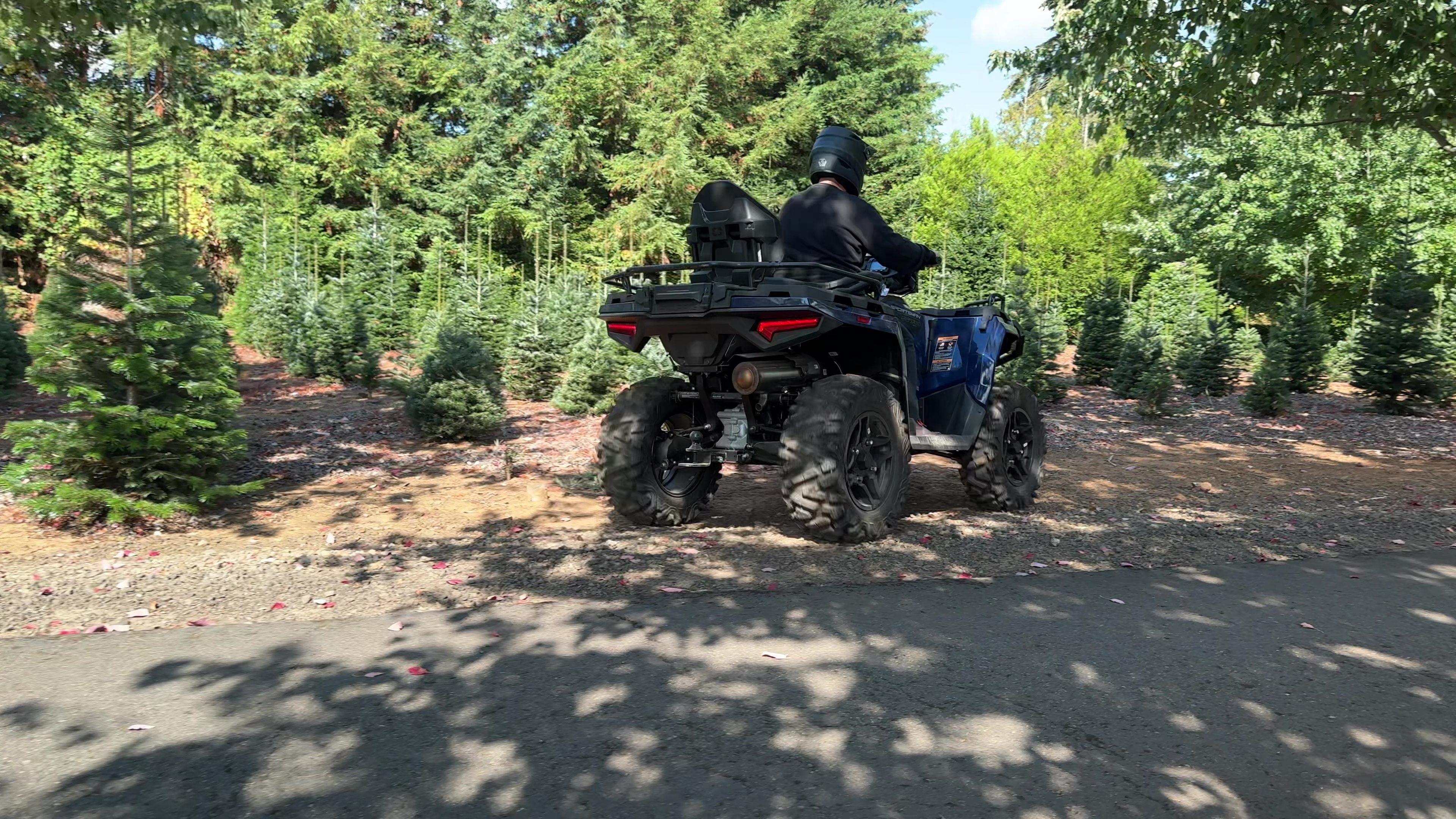 2025 Polaris Sportsman 570 Touring Premium riding on dirt