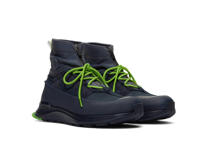 black trail sneakers with green laces