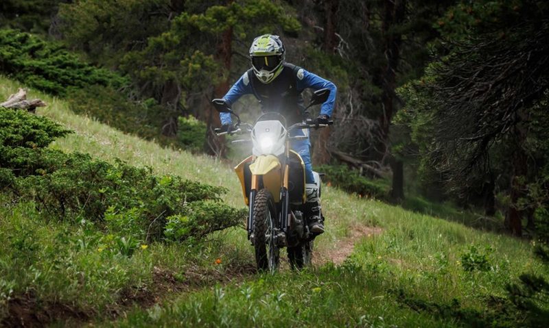 2025 Suzuki DR-Z4S dual-purpose on a hillside trail left front three-quarter view.