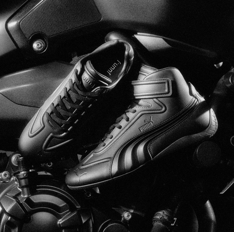 close up on speedcat sneakers on motorcycle