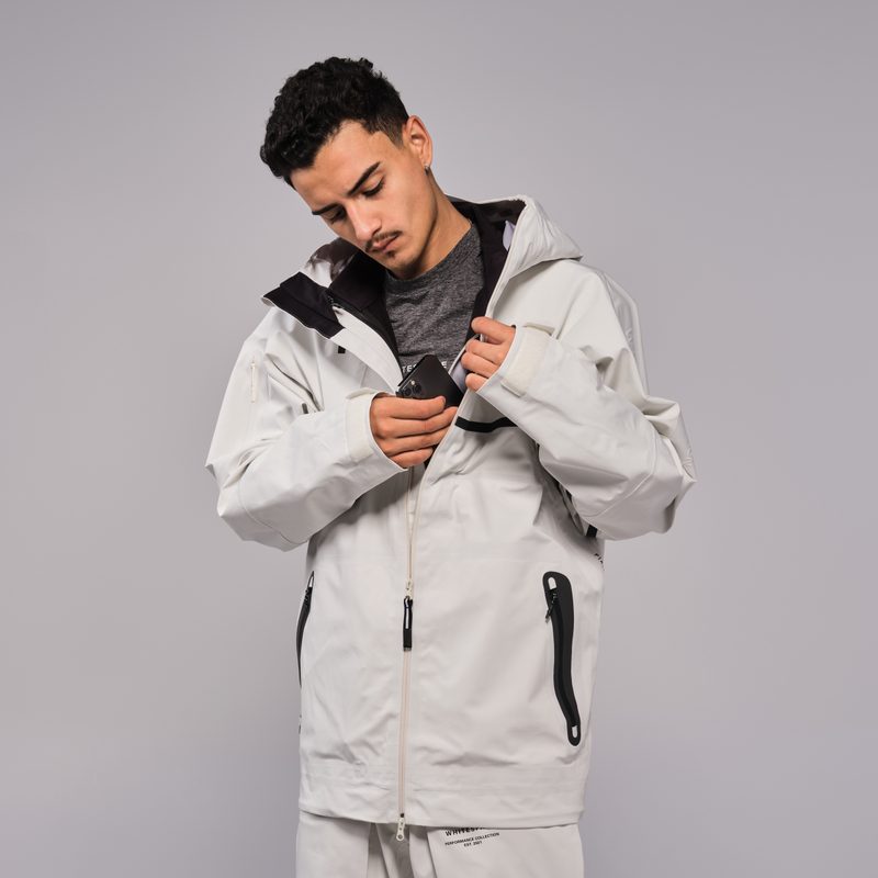 A man adjusts the inner layer of the WHITESPACE 3-in-1 jacket.