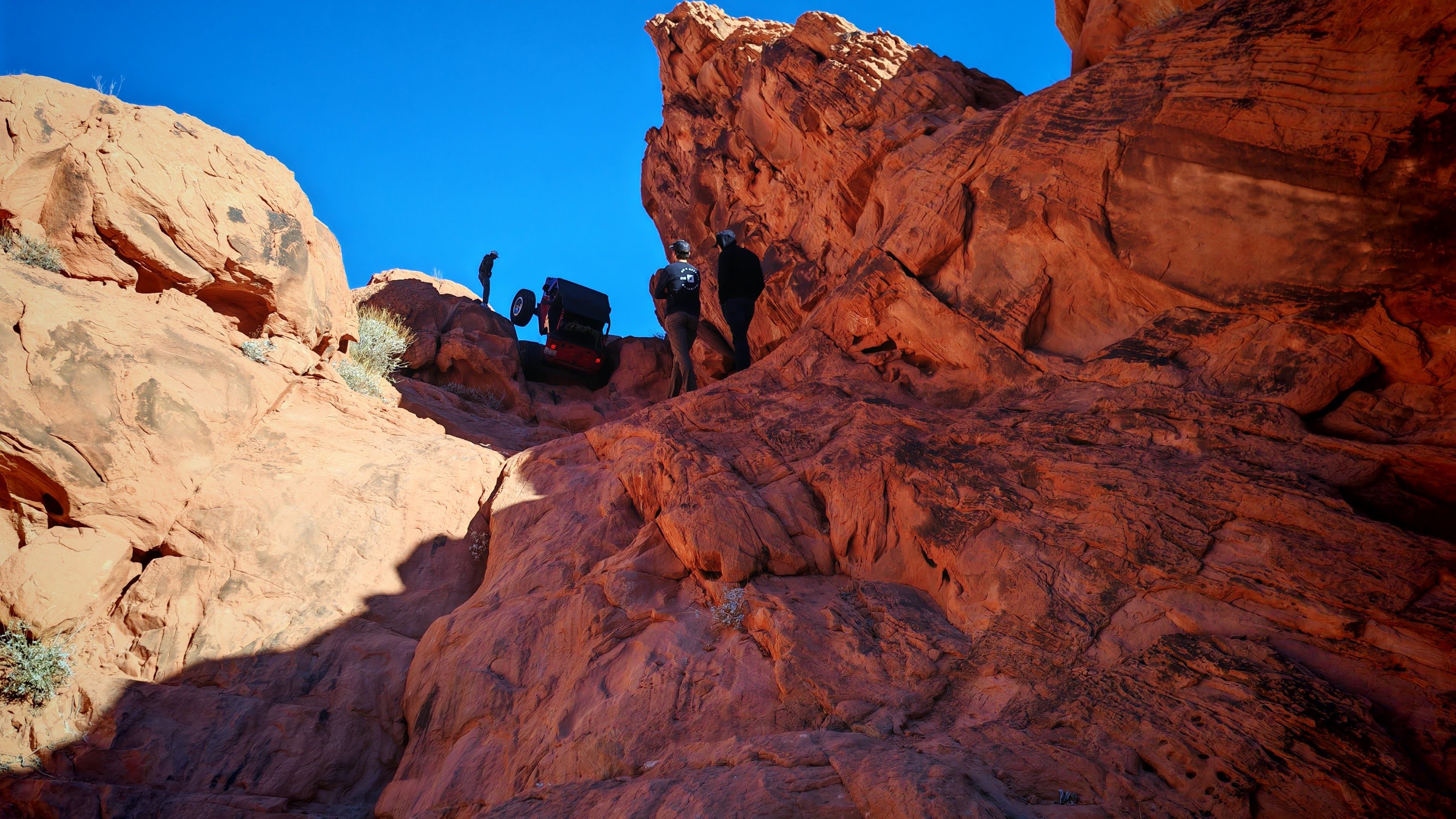 Jeep on a rock crawl with two wheels in the air